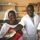 Senegalese doctor handing over mosquito net