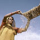 An Indian women sifting grain