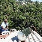 Installing a solar water heater on a roof: scientists say African leaders should look to basic science to help the poor