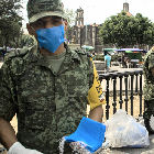 Mexican soldiers hand out face masks