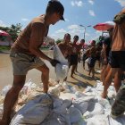 Placing sandbags to redirect flooding