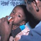 A child at St. Peter's TB Hospital, Addis Ababa, taking DOTS drugs