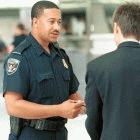 US Customs Inspector at an airport conducts an interview with a passenger