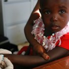 Young girl having blood drawn as part of malaria trial